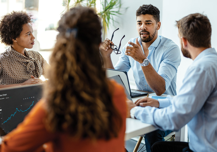 Four people talking around a table